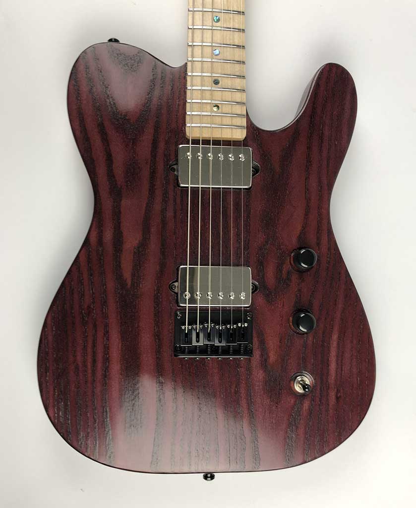 Munson Tempest SE one-off guitar with red-stained timber body and maple neck